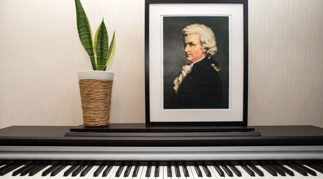 Framed portrait of Mozart above a piano with houseplant, representing Mozart K.448 and its connection to gut health and microbiome research